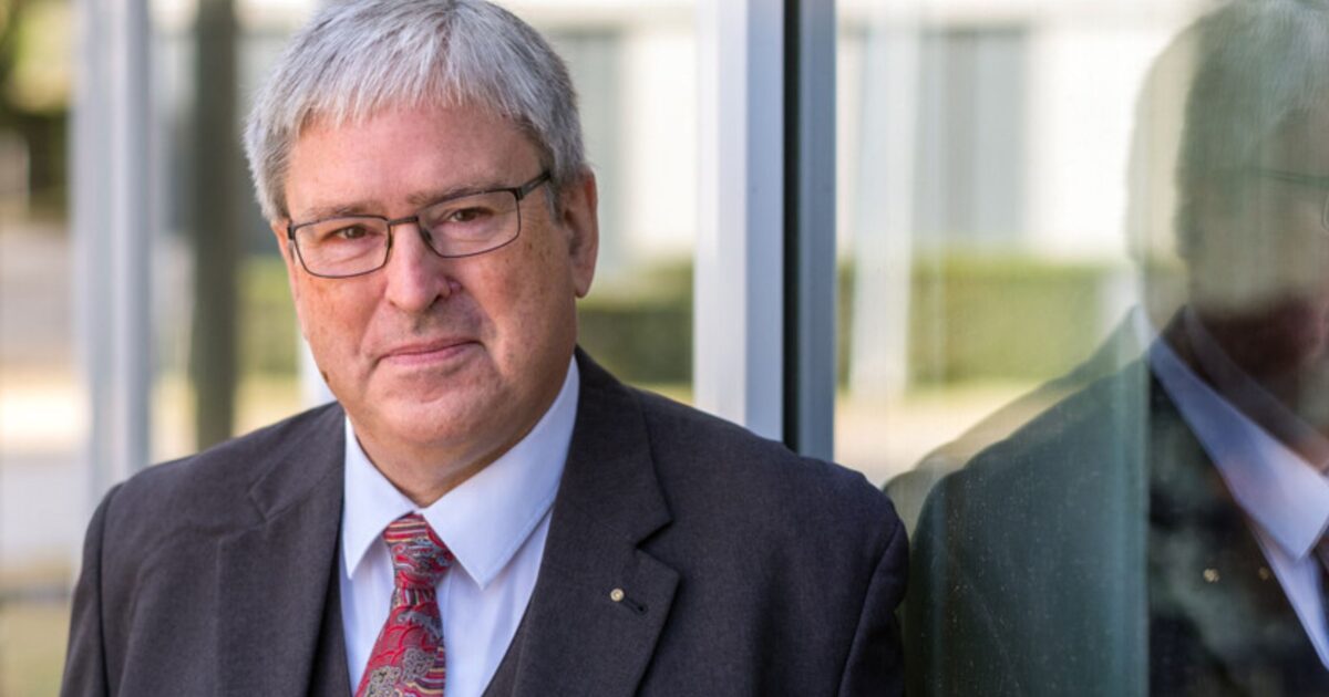 Brandenburgs Wirtschaftsminister Jörg Steinbach vor einer Glaswand