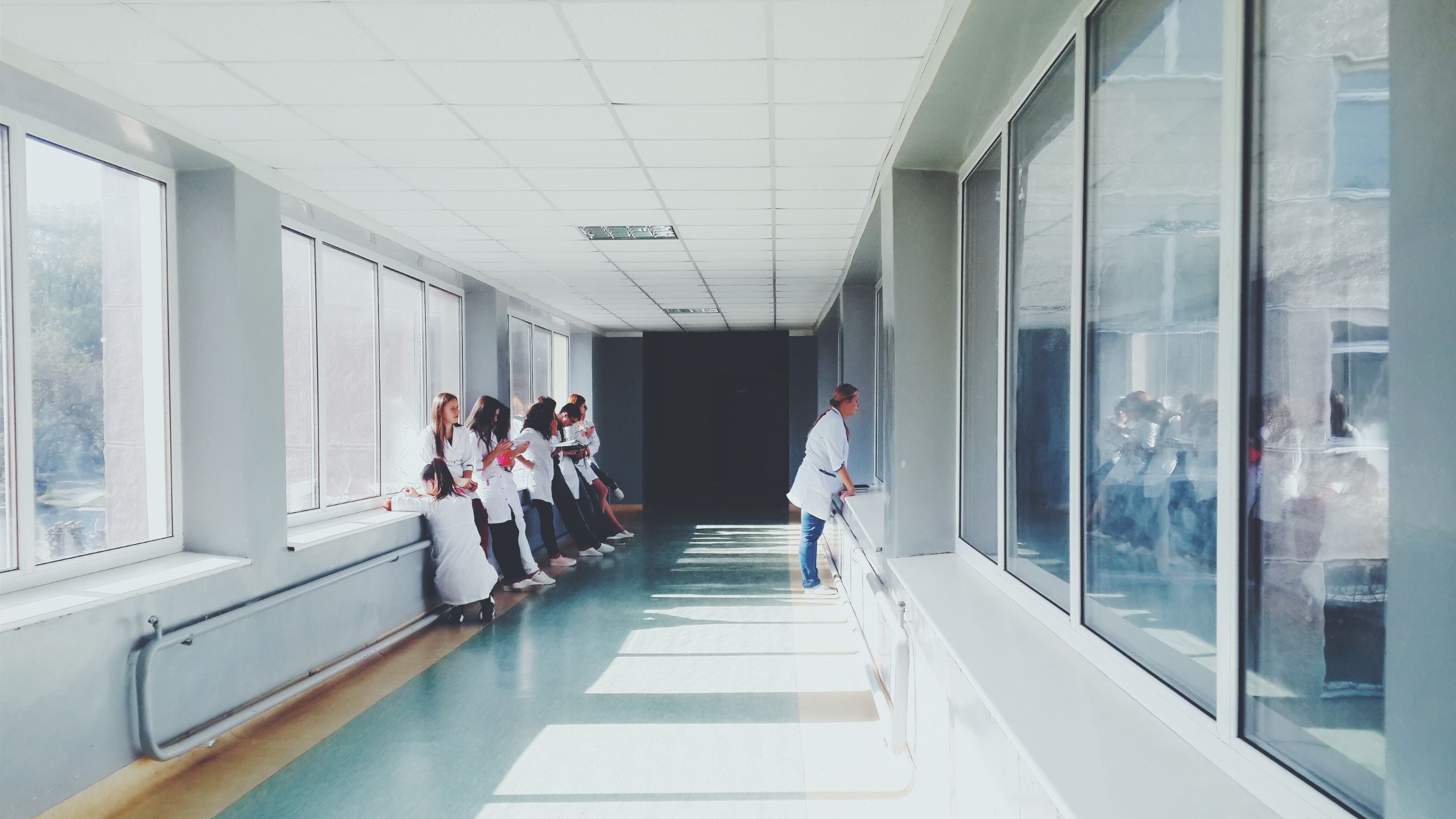 ein Krankenhausflur in dem mehrere Leute sitzen