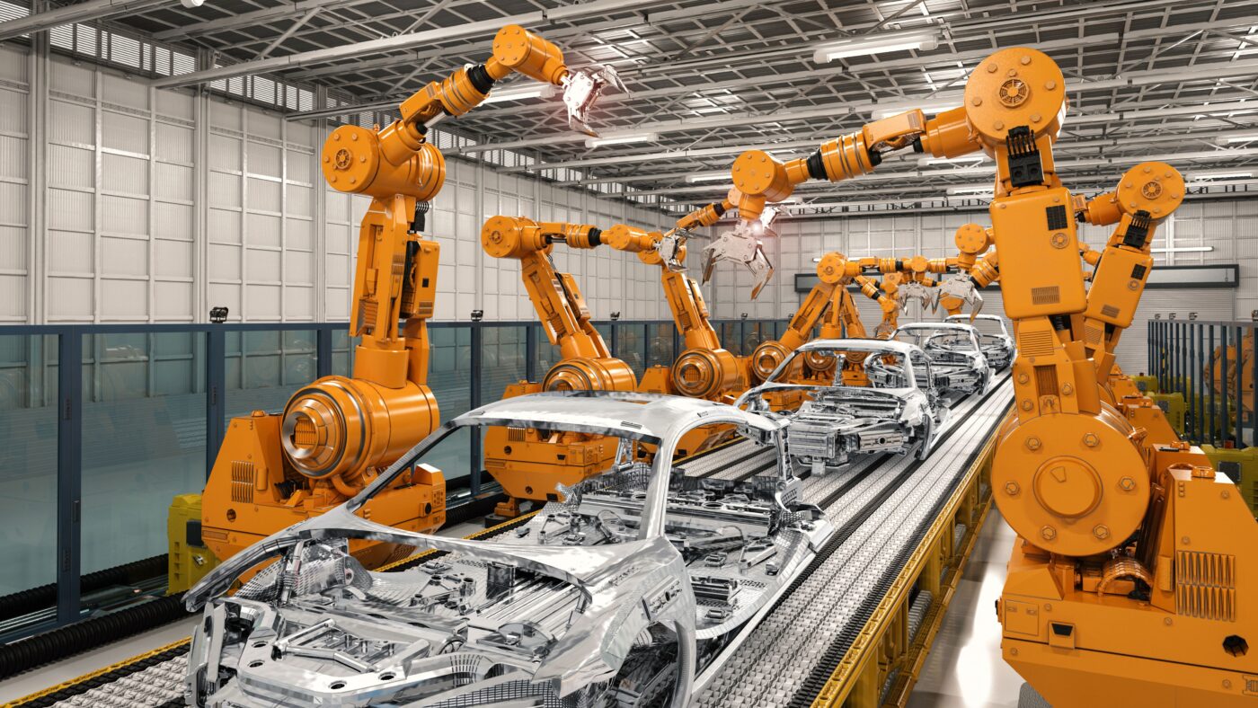 Roboterarme werkeln an Autokaroserien herum in einer Fabrik
