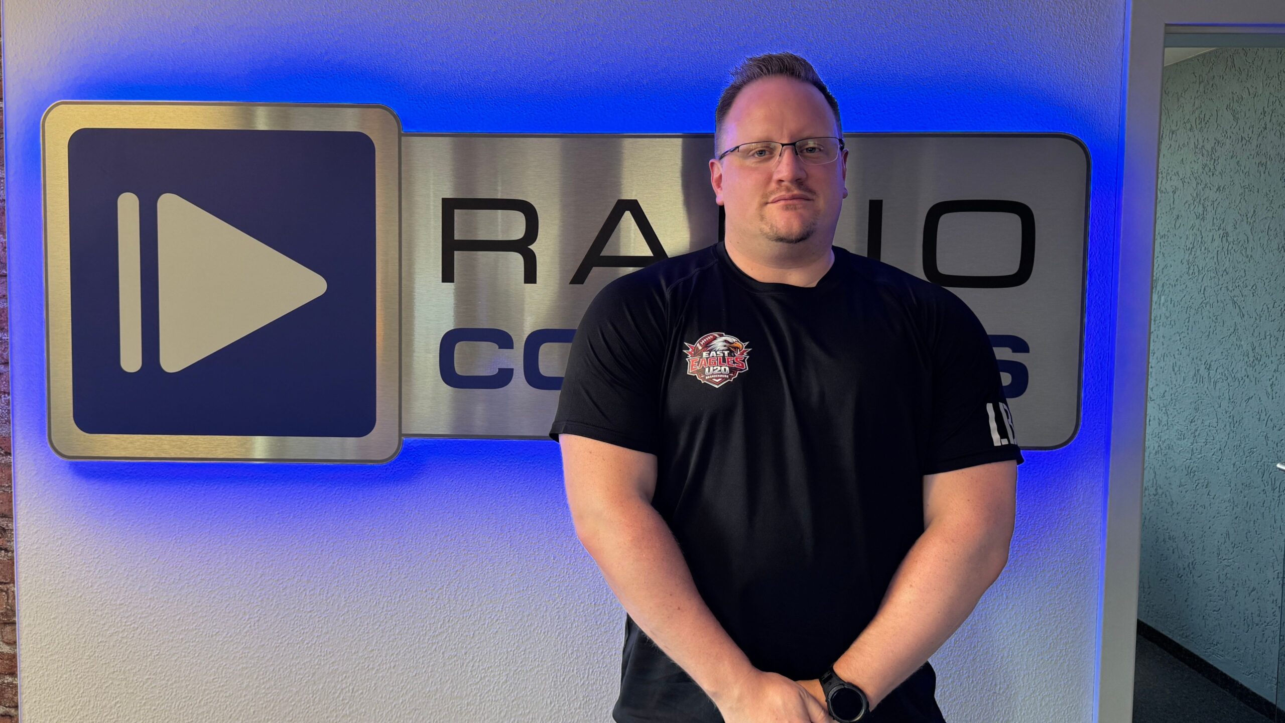 Sascha Schluckebier vor dem Radio Cottbus Logo